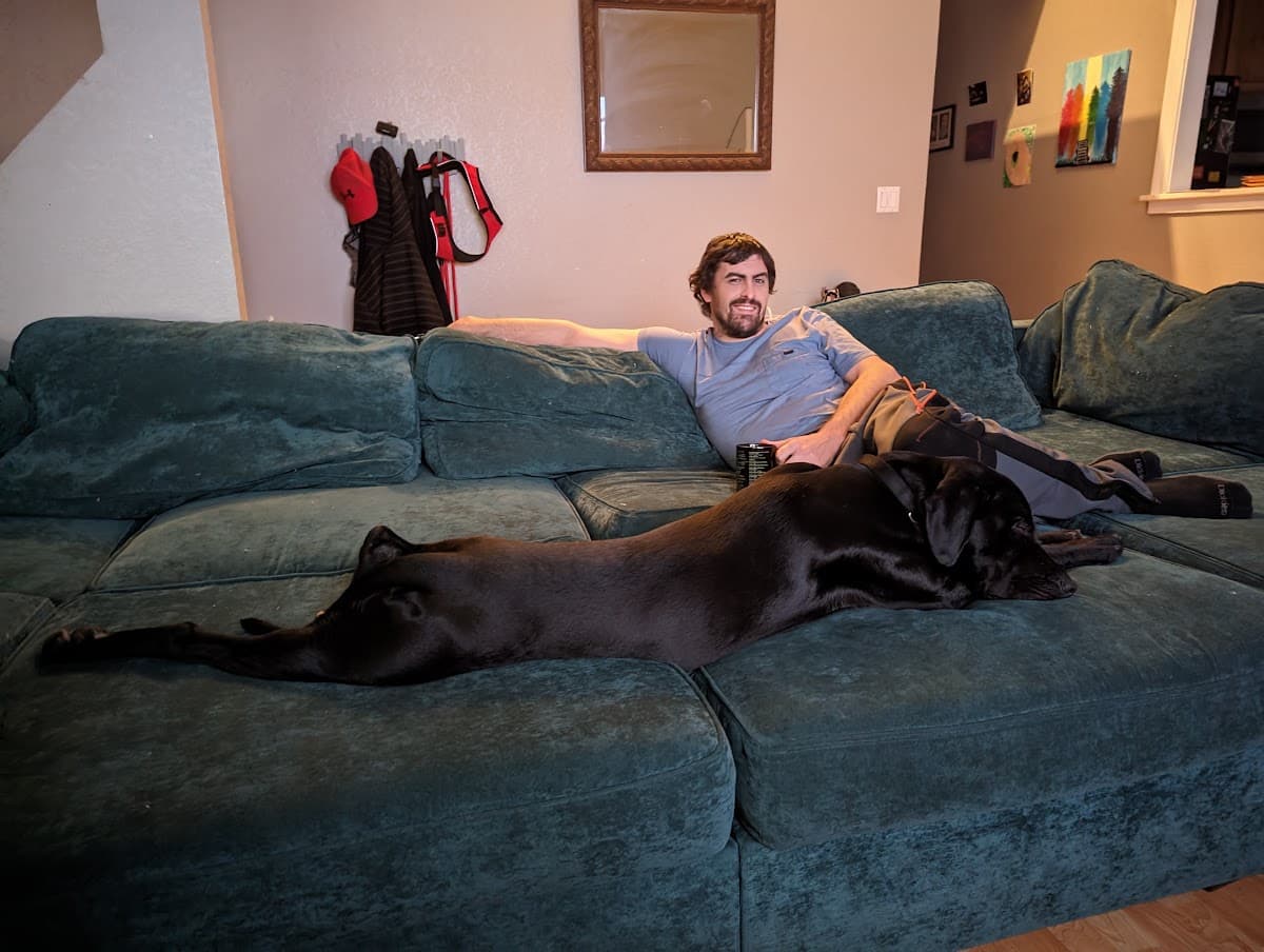 Russell Green relaxing at home with his dog